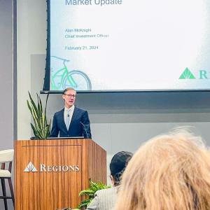 A person stood on stage speaking at an event