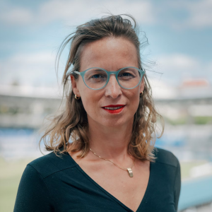 Person stands in front of blurred stadium