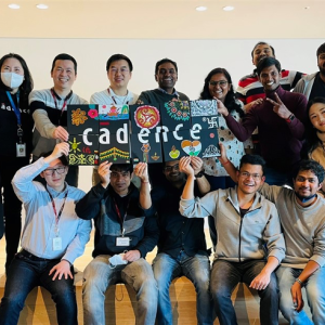 A group of employees holding up a Cadence sign