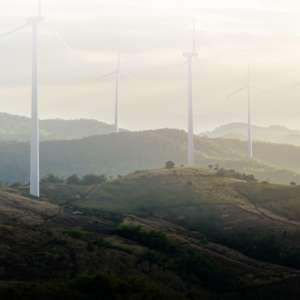 Mountains in the distance with wind turbines and a solar farm