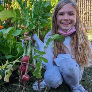 A child holding radishes