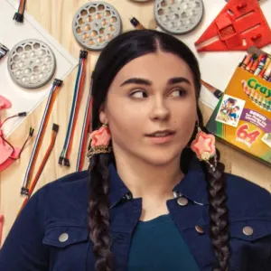 Danielle Boyer laid down surrounded by craft supplies