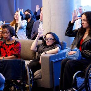 A group of people practicing sign-language.