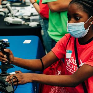 a child using a joystick controller in a flight simulator