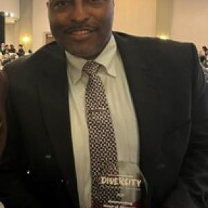 Kyle Pierce holding his award from the Houston Business Journal's 2023 Head of Diversity Awards