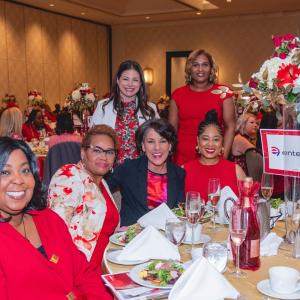 A group of women posed at a table.