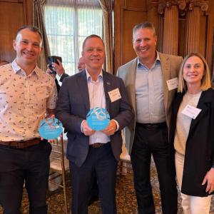 DP World recipients standing with their blue circle award 