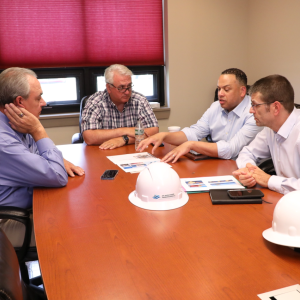4 people sitting at a meeting