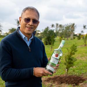CEO Mahesh Madhavan with a Bacardi bottle