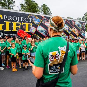 Giving Back specialist addressing group of volunteers