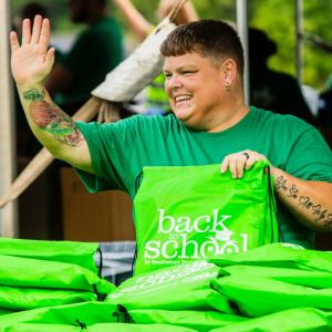 Volunteer waving at passerby