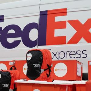 A FedEx express van, Boxes and backpacks with Direct Relief logos in front.