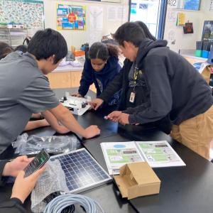 A team of students working on solar battery kit.