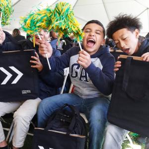 Saint Rest Baptist Church youth enthusiastically reacting to their free personal laptops during a Project UP digital equity event in Fresno. 