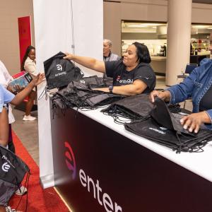 Volunteers hand out bags to others.