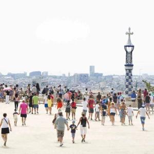 panoramic view of tourist spot in Barcelona. Many families and small groups walking around.