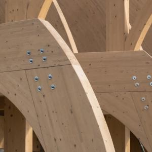 row of wood beams and rivets