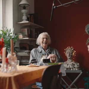Someone laughing while sitting at a table