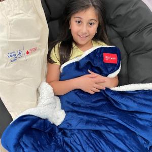 child snuggled under a blanket