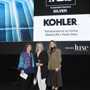 Three people in front of a sign "Best of KBIS Silver. Kohler"