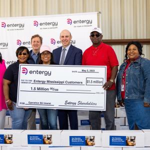 A group of people holding a large check.
