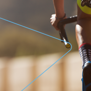 A person on a racing bicycle, riding away from the camera.