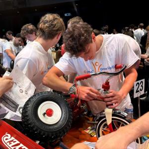 Interns and volunteers working together to assemble bikes and wagons.
