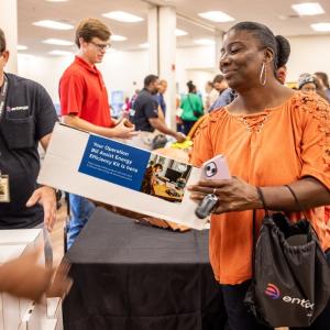 A person receiving an energy saving kit at the event.
