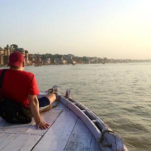 Scott on the bow of a boat on an open expanse of water