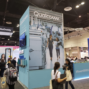 people walking around Qualcomm's booth