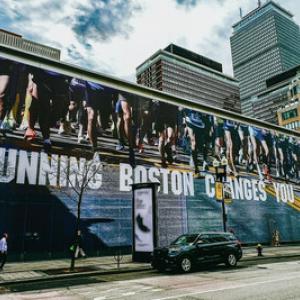 Large mural on the side of a building "Running Boston Changes You".