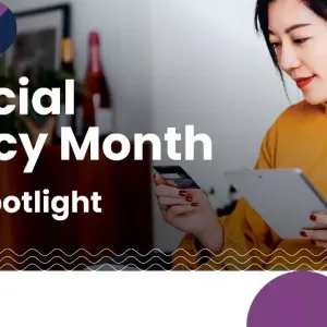 A person looking at a piece of paper and credit card. "Financial Literacy Month Benefit Spotlight"