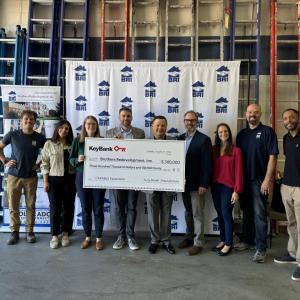 People posing with an oversized check
