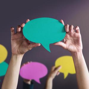 people holding up conversation bubbles 