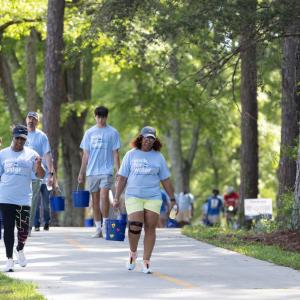 Participants walking with buckets of water 