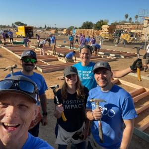 Posing for a selfie in front of the construction of a home