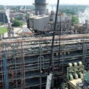 Aerial view of huge power plant, steam stacks to the right.
