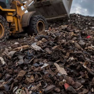 Bulldozer scoops up automotive waste