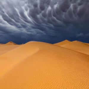 Sand dunes with stormy sky