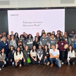 A large group of people posed in front of a large digital display "Welcome to Career Discovery Week!"