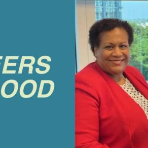 Pioneers for good | Carita Hughes in a red jacket, smiling