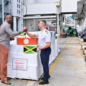 Former NBA Miami Heat Center Alonzo Mourning and Carnival Horizon Captain Niccolo De Ranieri supervise the loading of medical aid onto the Carnival Cruise ship departing for Jamaica on Dec. 14, 2025. (Brea Burkholz/Direct Relief)