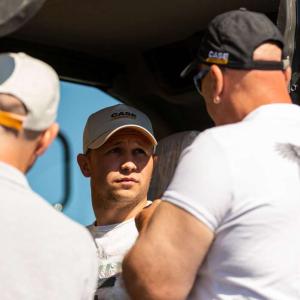 3 people on a piece of construction equipment