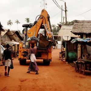 A piece of machinery driving through a street 