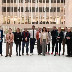 A line of people posed in an open area.