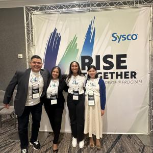 Four people standing together