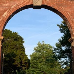 A tall brick archway entrance to the cemetary.