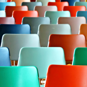 Rows of colorful empty chairs.