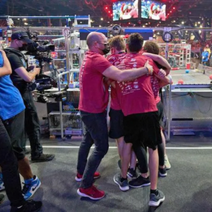 teams in different color shirts hugging