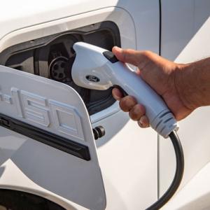 person plugging in a car